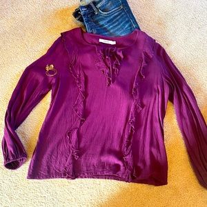 Beautiful blouse with ruffles and tie down the front.